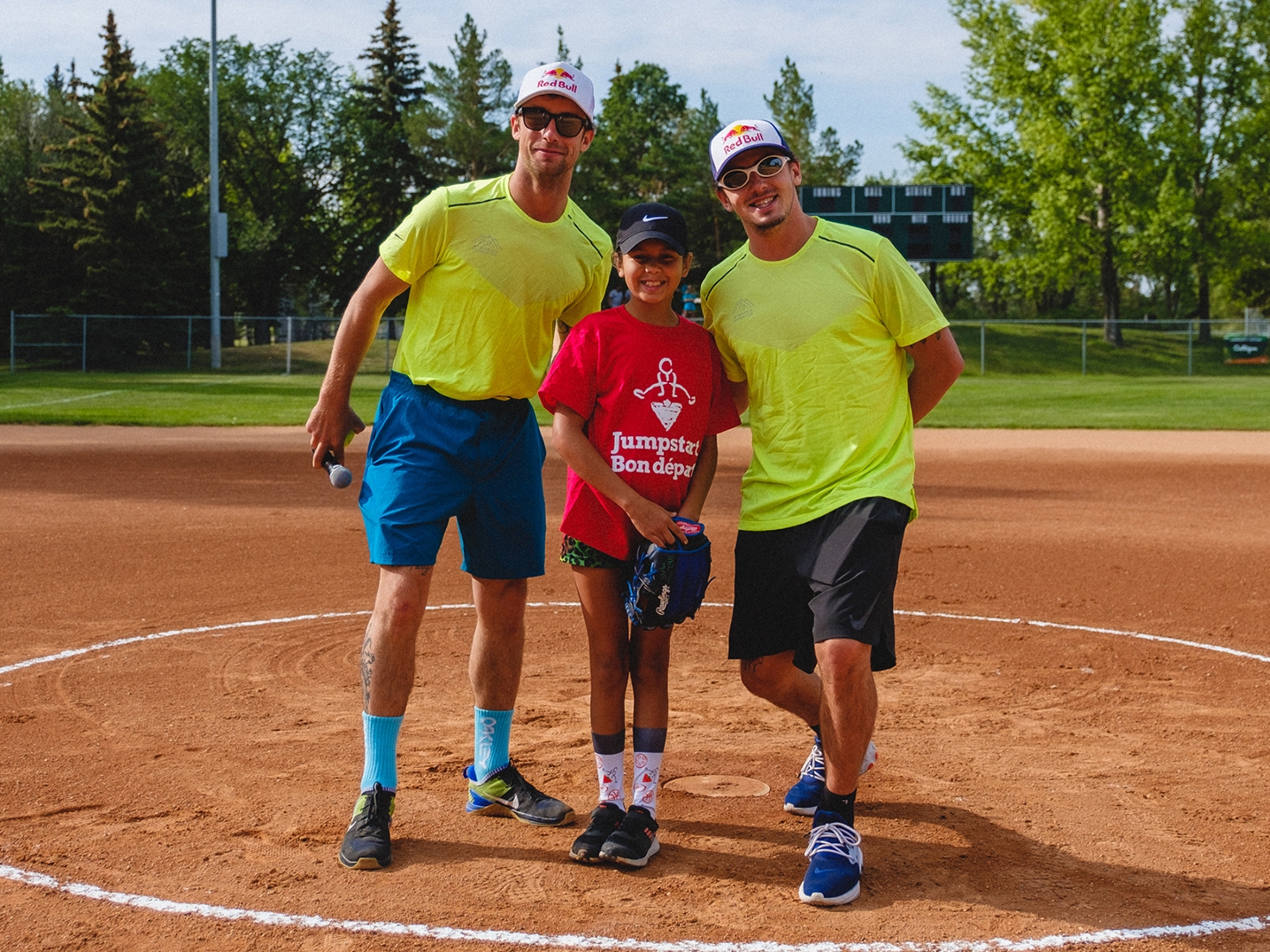 team posing with young child